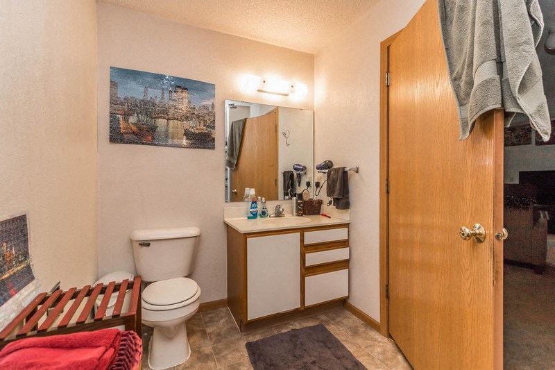 a bathroom with a toilet and a sink and a mirror