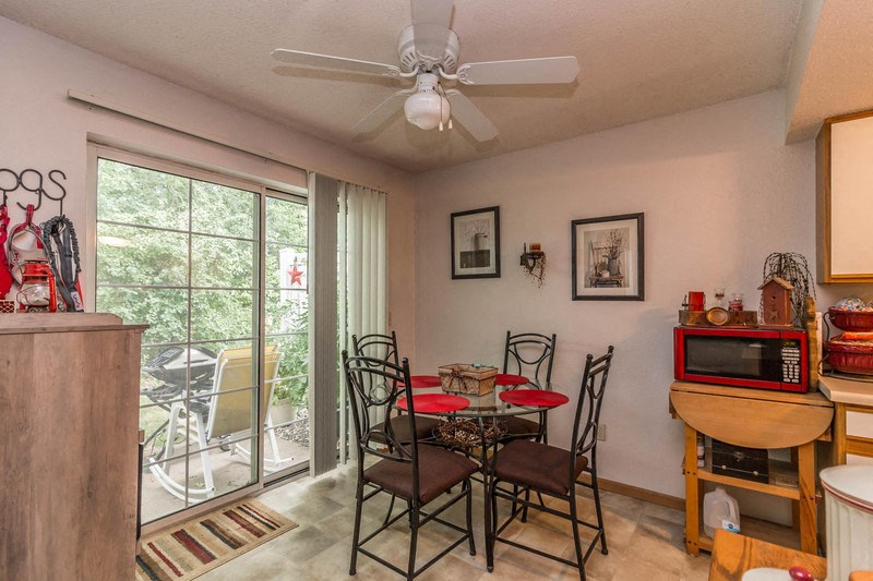 a dining room with a table and chairs and a ceiling fan