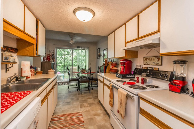 a kitchen with a stove top oven and a sink