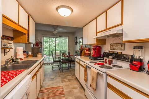 a kitchen with a stove top oven and a sink