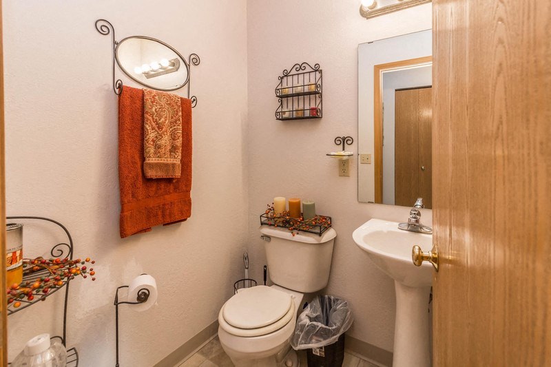 a bathroom with a toilet and a sink and a mirror