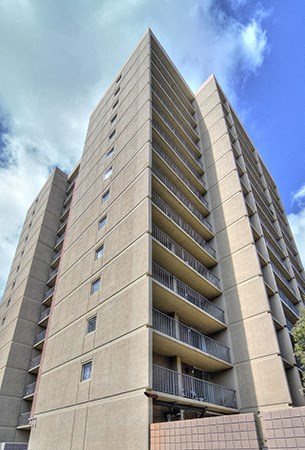 a tall building with a blue sky in the background