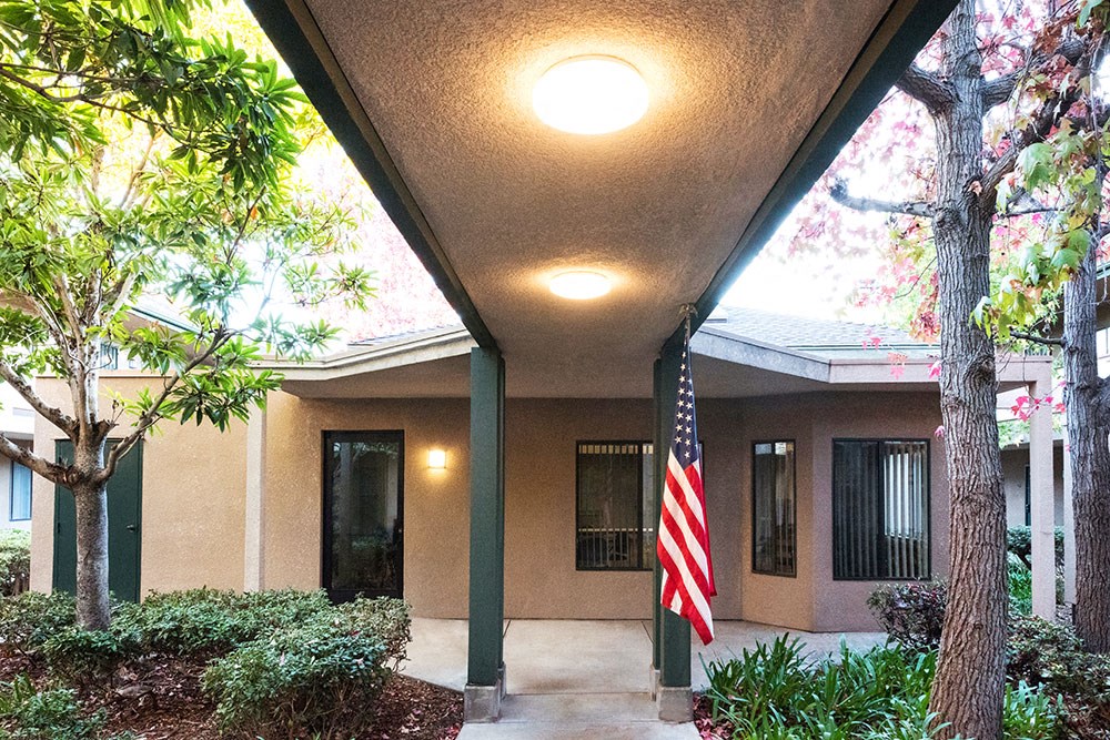 a home with an flag outside of the front porch