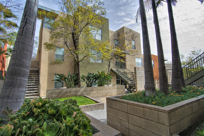 a view of a building with trees and a courtyard
