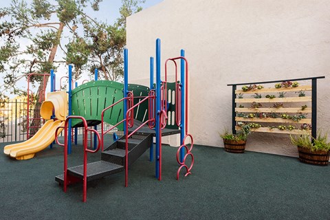 a playground with a slide and a bench