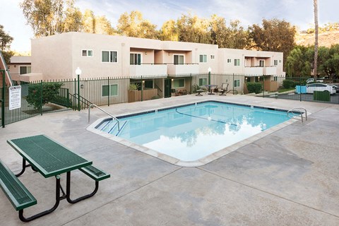 our resort style swimming pool is next to our building and a picnic table