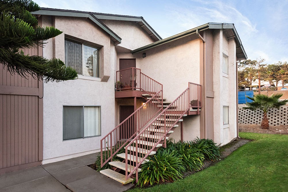 a building with stairs and a window on the side of it