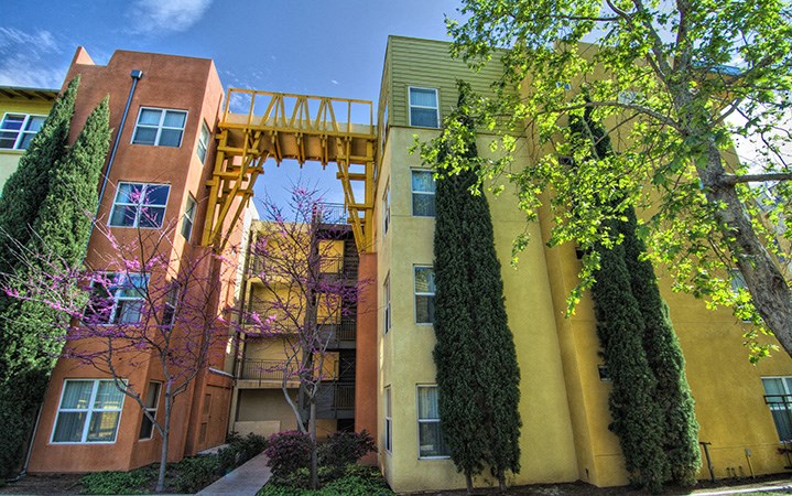 a view of two buildings with a bridge between them