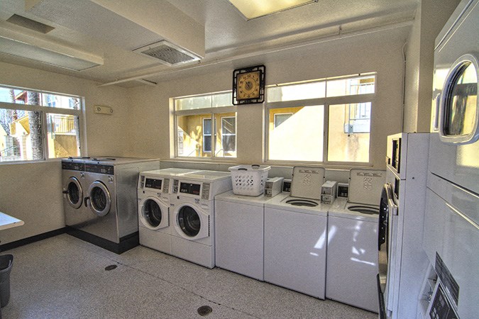 a laundry room with a bunch of washing machines