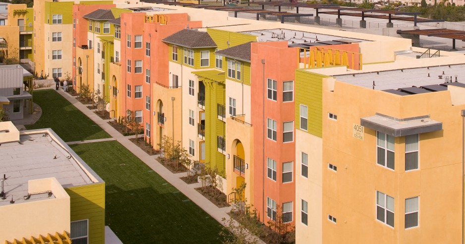 an aerial view of colorful apartment buildings on a city street