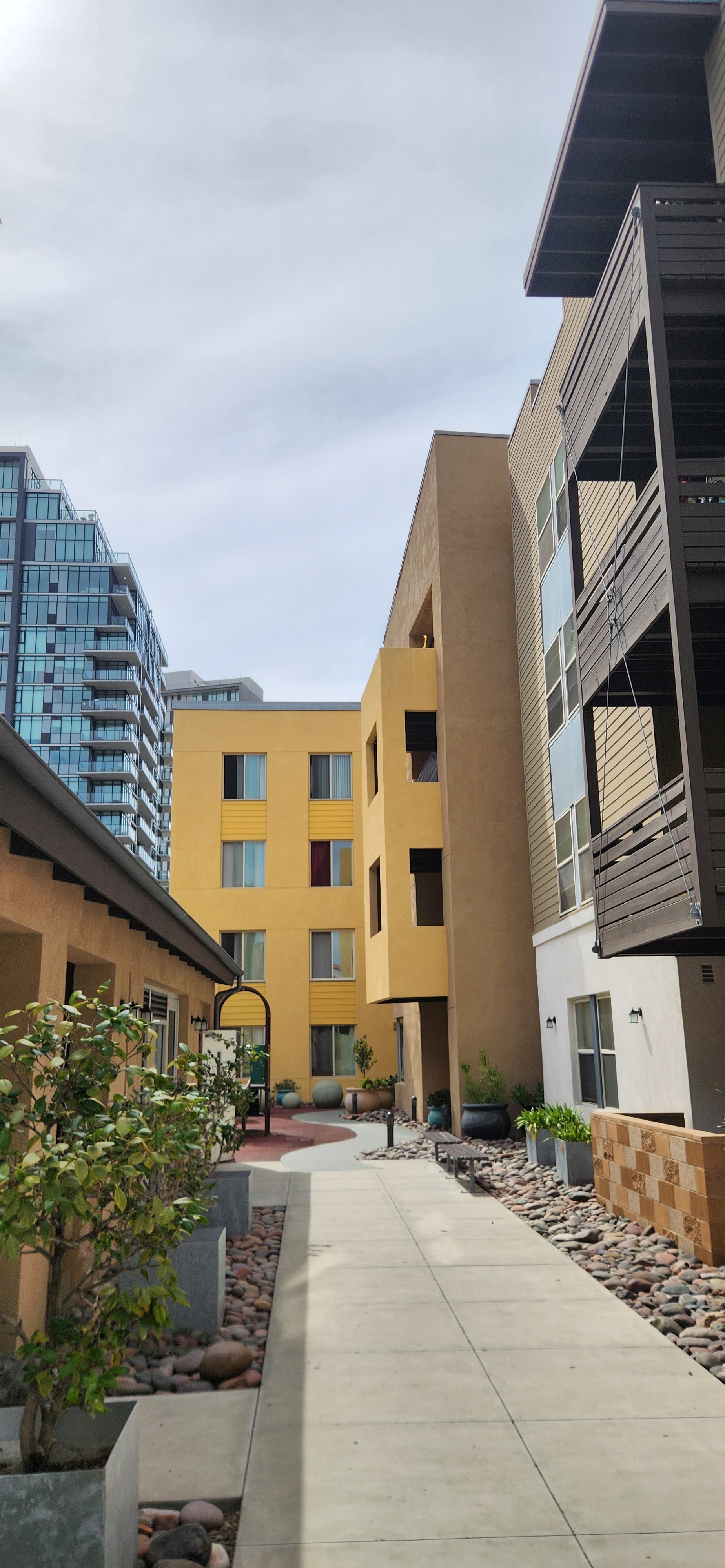A yellow building is in the background of a city street.