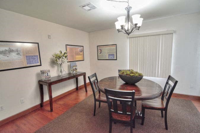 a dining room with a table and chairs