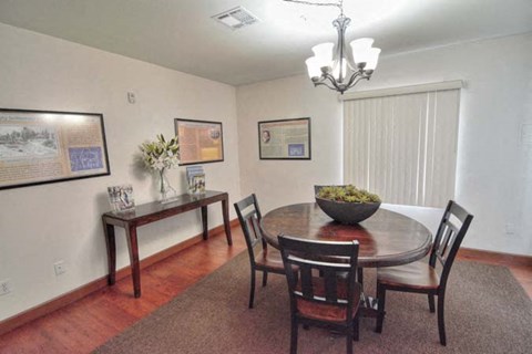 a dining room with a table and chairs