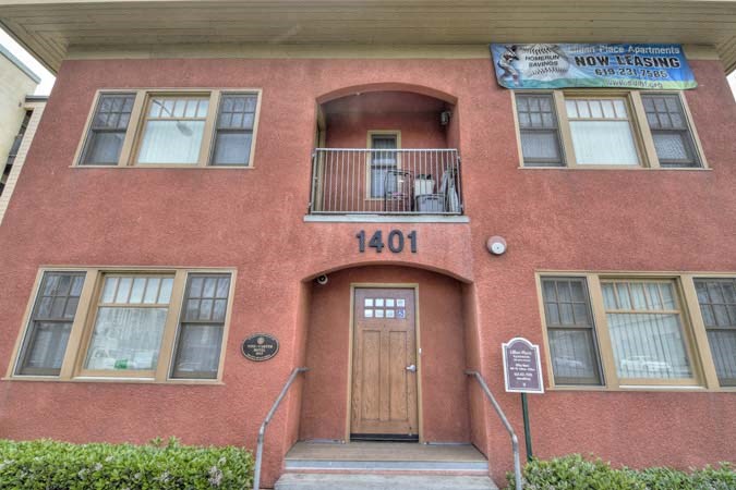 a red brick building with a wooden door and stairs