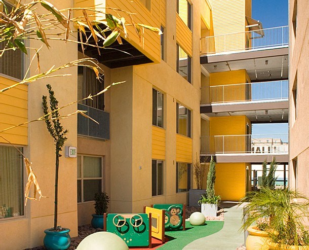 an outside view of a building with plants and a green courtyard