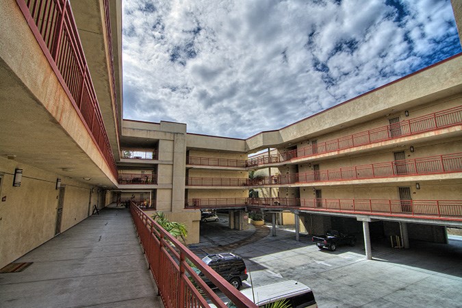 a view of an empty parking lot in an apartment building