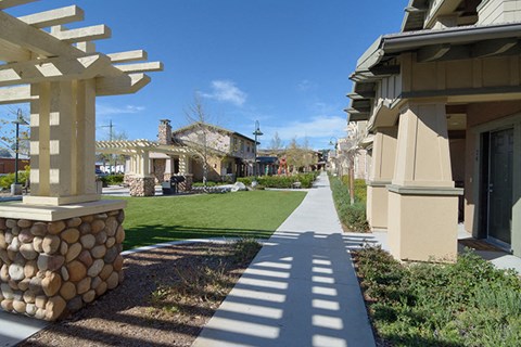 a view of a sidewalk in front of some houses