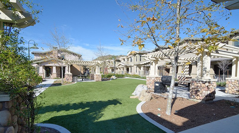 a view of the front yard of a house with green grass and a lawn