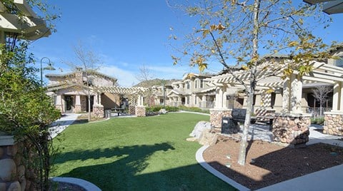 a view of the front yard of a house with green grass and a lawn
