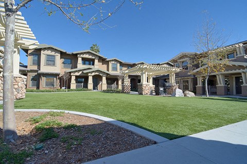 a group of houses with a lawn in front of them