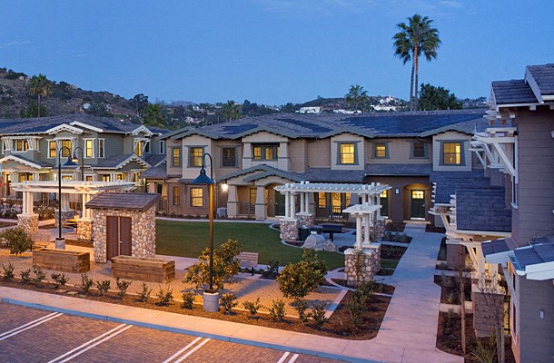 a rendering of a large house with a yard and a fountain