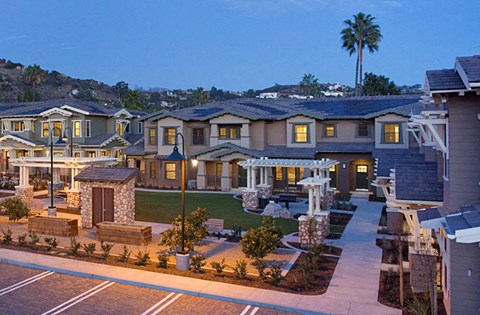 a rendering of a large house with a yard and a fountain