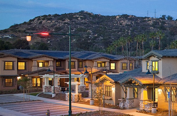 a row of houses with a mountain in the background