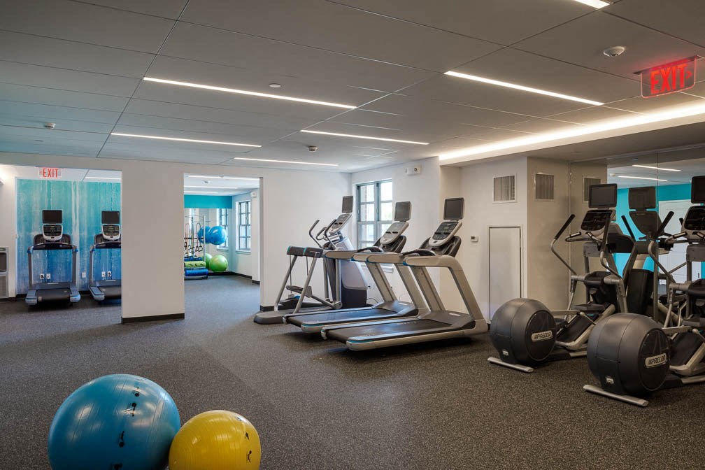 a gym with weights and other exercise equipment in a building