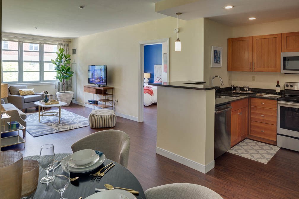 a kitchen and living room with a table and chairs