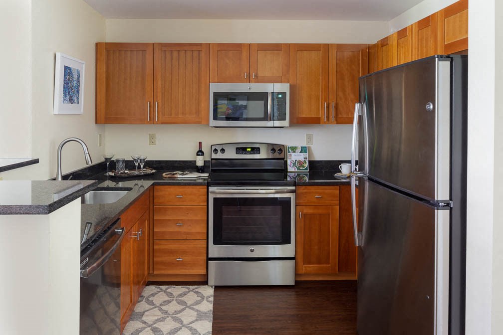 a kitchen with stainless steel appliances and wooden cabinets