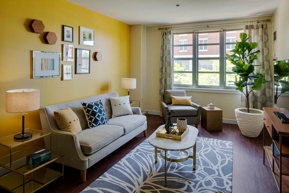 a living room with yellow walls and a couch and a table