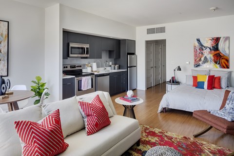 a living room and kitchen with a couch and a table