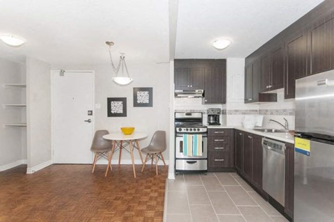 A kitchen with a table and chairs in the middle of the room.