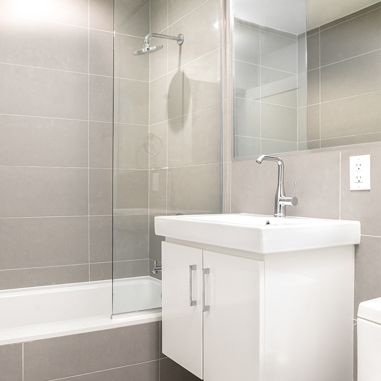 a small bathroom with a sink and a shower