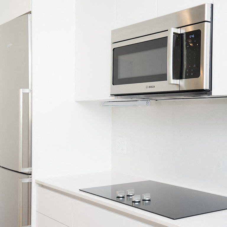 a kitchen with a microwave and a refrigerator