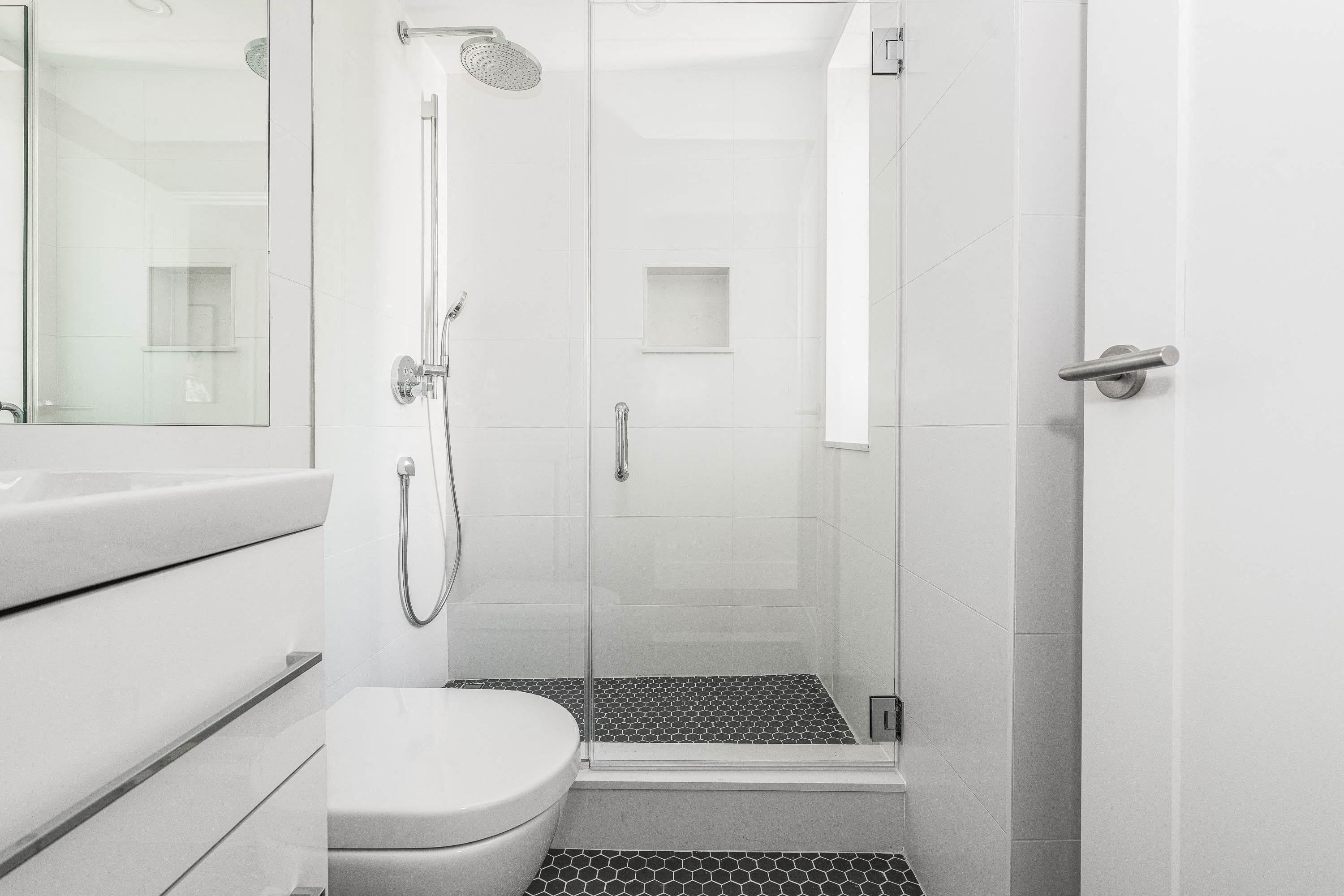 stylish bathroom with chrome fixtures and a rain shower