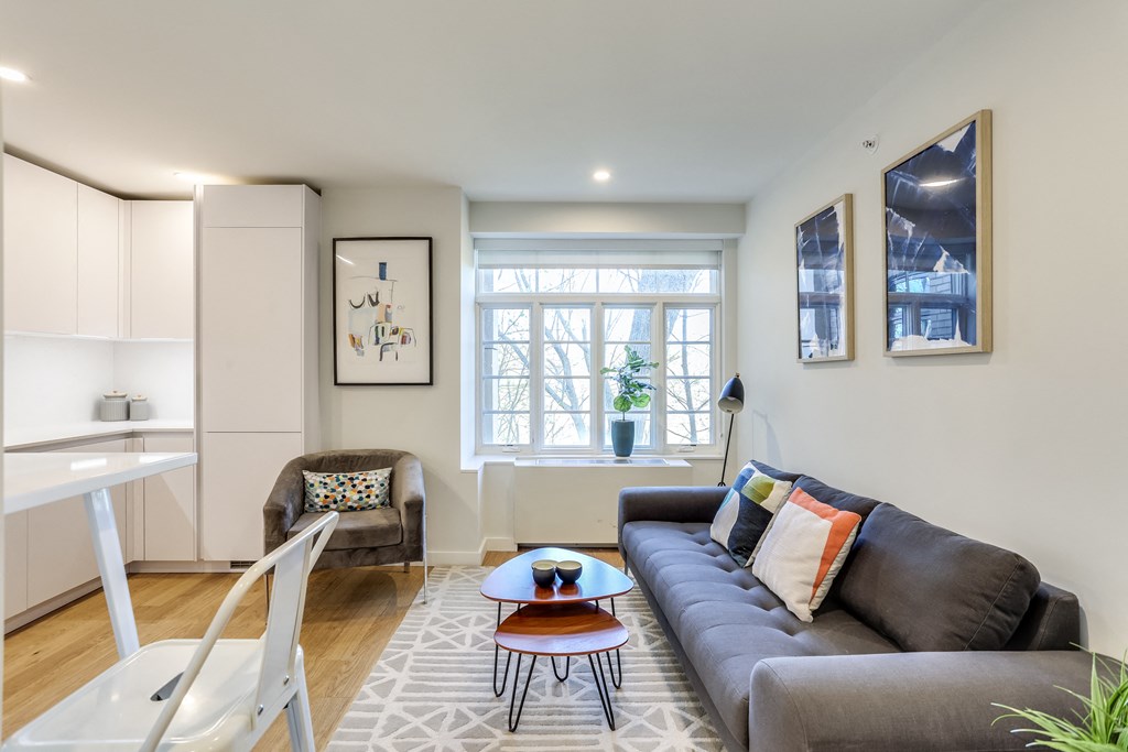 a living room with a couch and a chair and a table