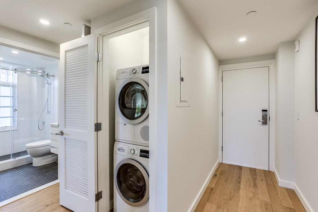 a washer and dryer in a laundry room next to a white door