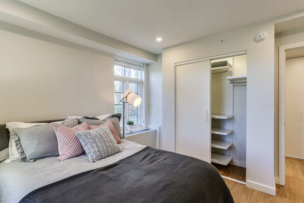 a bedroom with a large bed and a closet