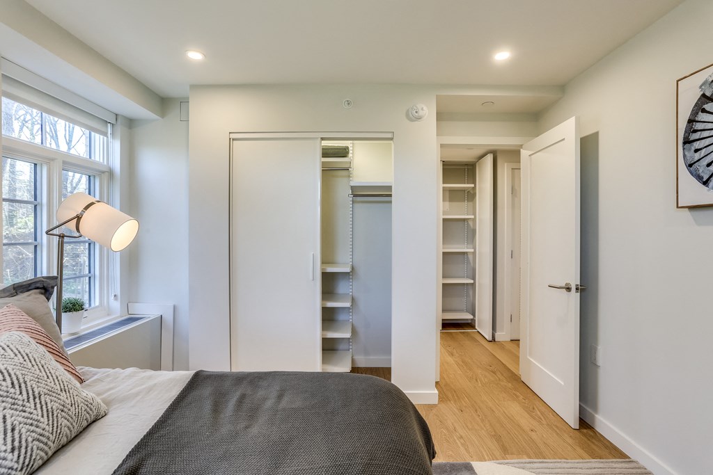 a bedroom with a large bed and a closet with shelves