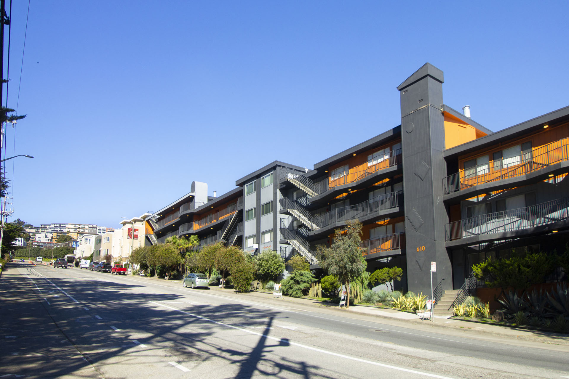 A street view of a residential area with apartment buildings.