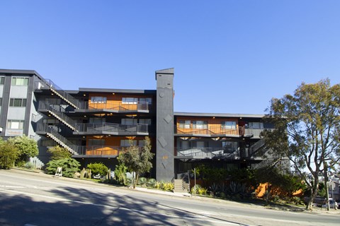 A modern building with a black exterior and orange accents.