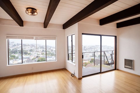 A large empty room with a view of the city.