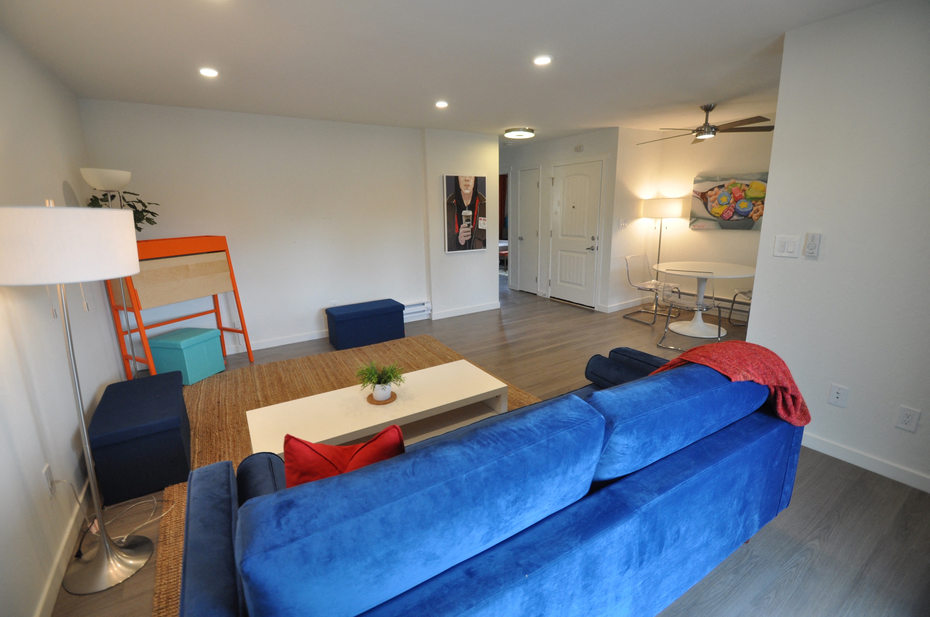 a living room with a blue couch and a coffee table