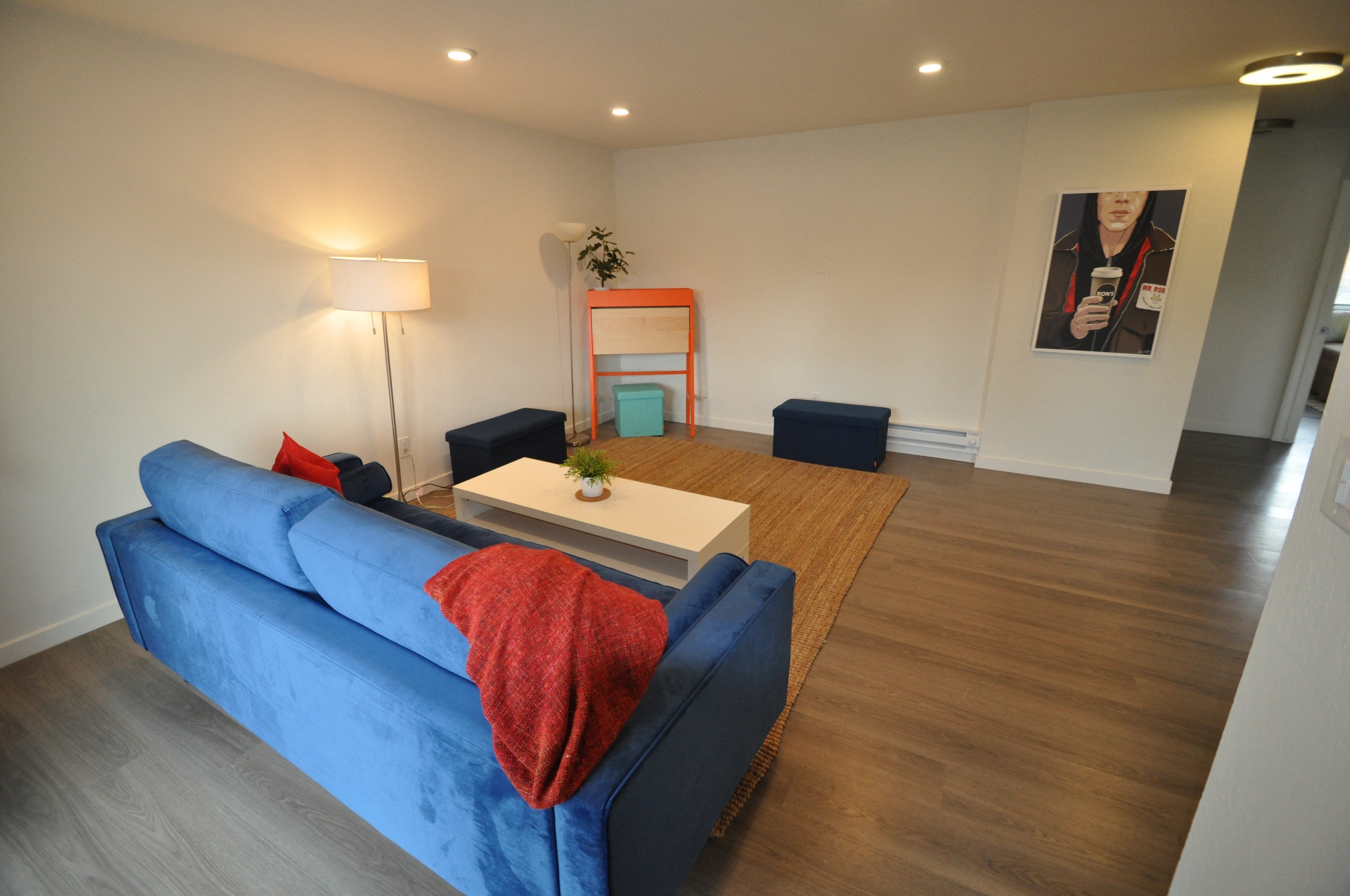a living room with a blue couch and a coffee table