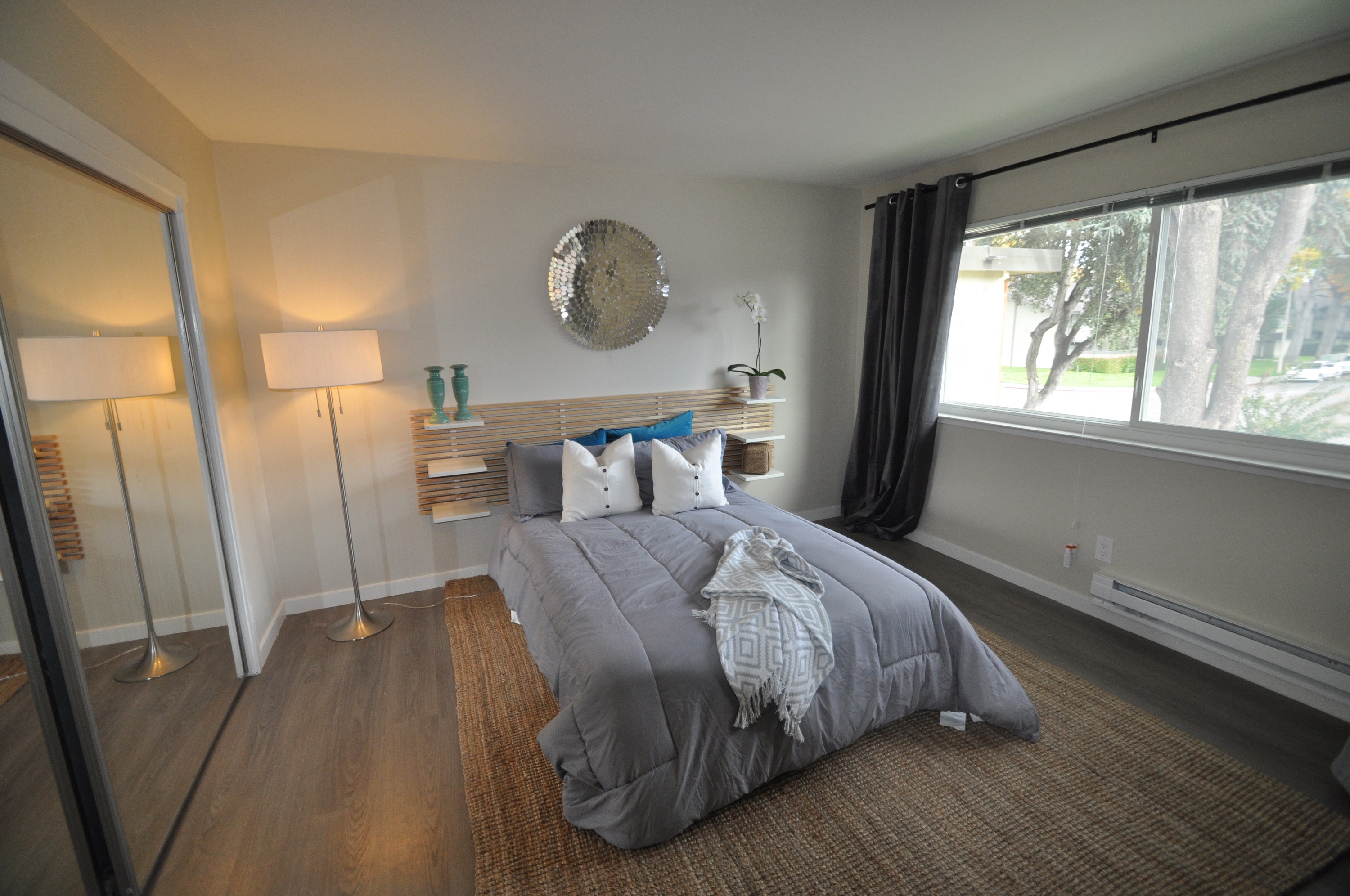 a bedroom with a bed and a large window