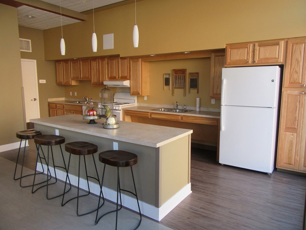 a kitchen with an island with four stools in front of it