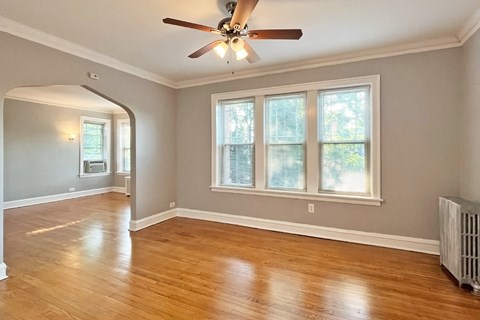 A room with a ceiling fan and a window.