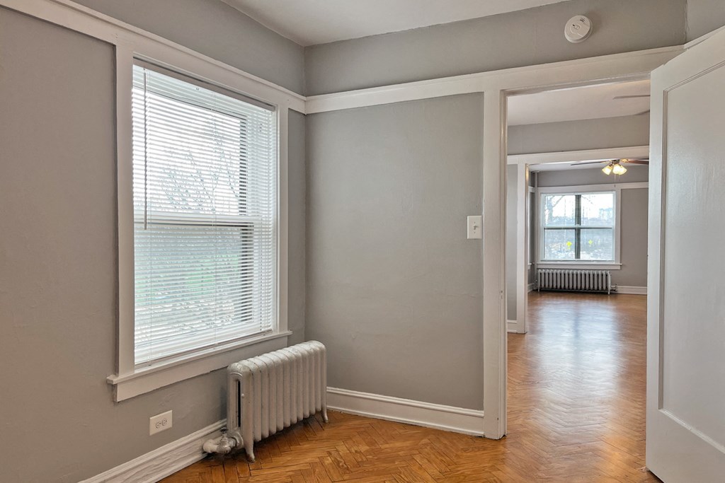 A room with a window and a radiator on the wall.