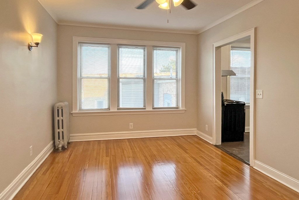 a brick building with a green sign on the side of it